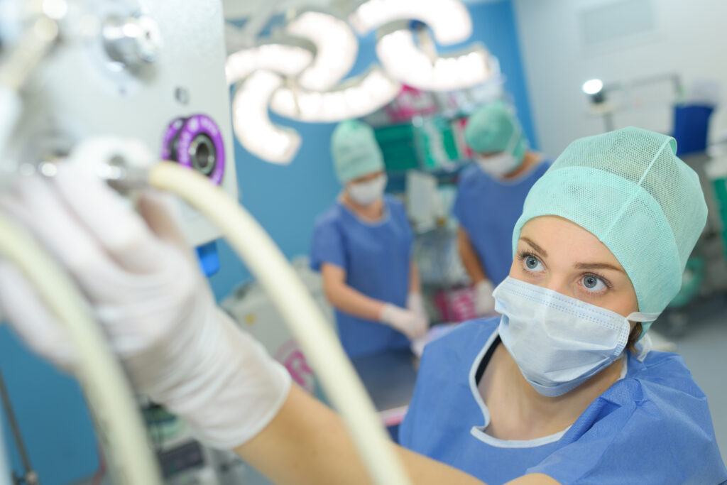 surgery assistant perfusionist operating a modern heart lung machine